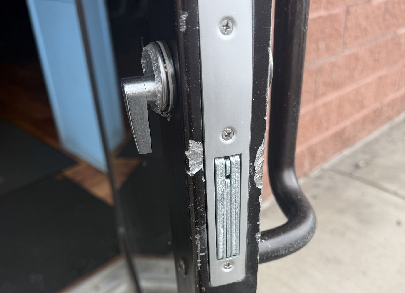 Commercial locksmith opening an office door