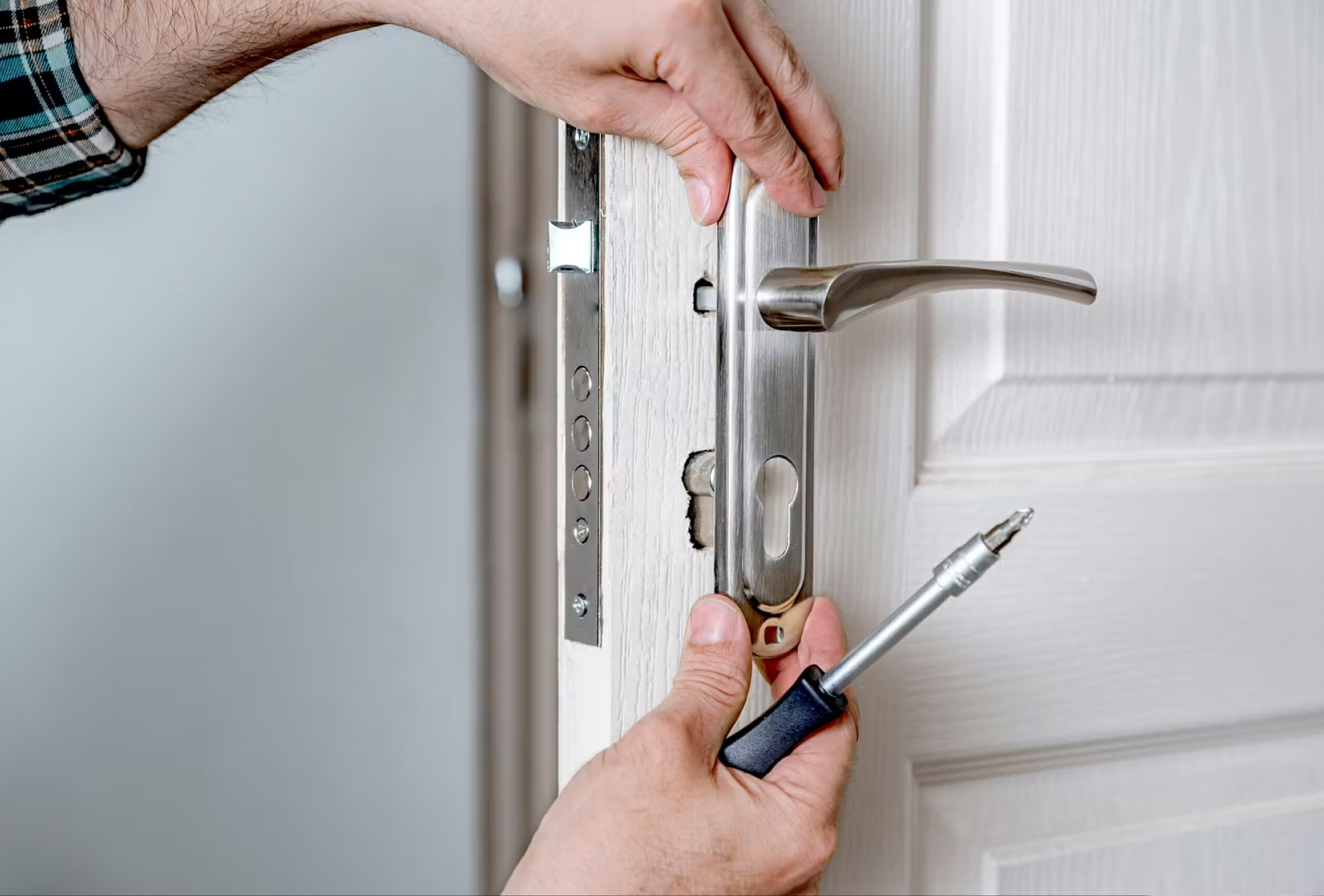 Locksmith rekeying a residential door lock