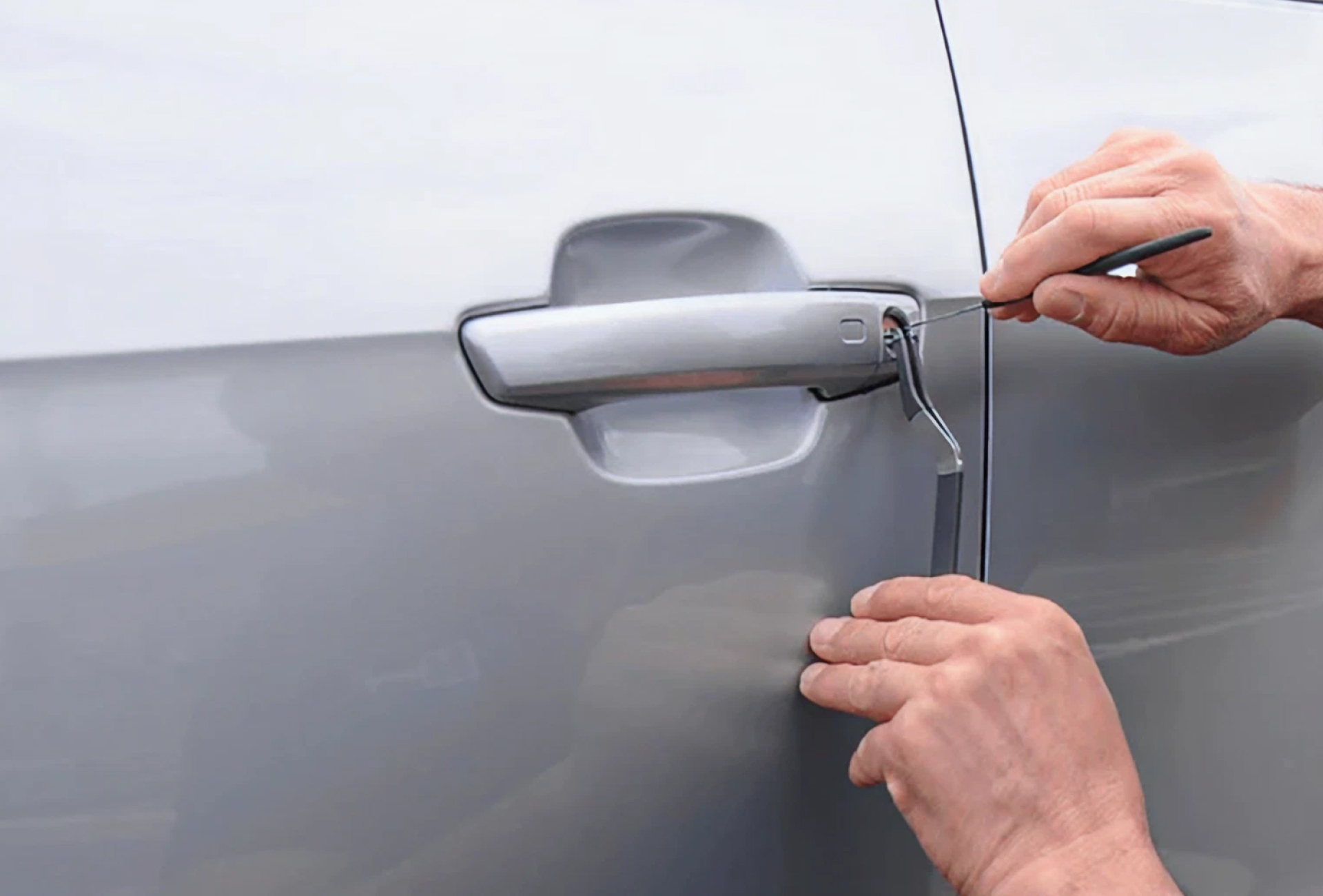 Automotive locksmith unlocking a car door